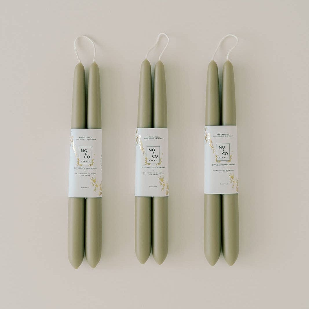 Three pairs of green taper candles.