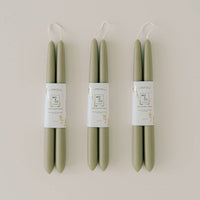 Three pairs of green taper candles.