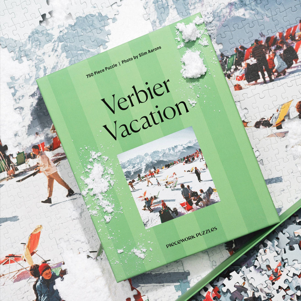 Jigsaw puzzle box titled 'Verbier Vacation' with scattered pieces on a snowy background