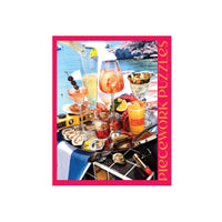 Jigsaw puzzle box with a scenic outdoor setting featuring drinks and food.