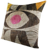 Decorative patterned pillow with pink center.