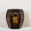 A vintage octagonal ceramic stool with a glossy dark brown glaze and hand-painted floral motifs in yellow, green, and orange, set against a plain off-white background.