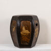 A dark brown hexagonal ceramic stool with glossy brown glazed panels depicting a rabbit and lotus flowers, set against a plain off-white background.