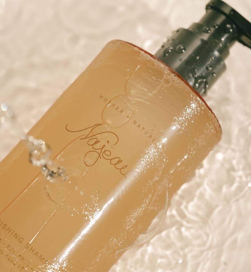 Close-up of a beige bottle with 'Mother Nature' branding on a textured background