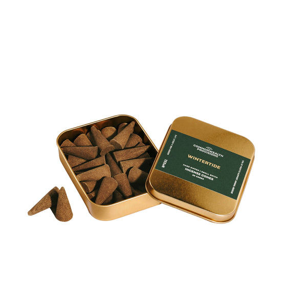 Gold tin with incense sticks labeled 'Winter Tide' on a light gray background
