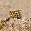 Gold ring with green gemstones