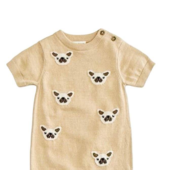 Beige baby romper with embroidered dog faces on a white background
