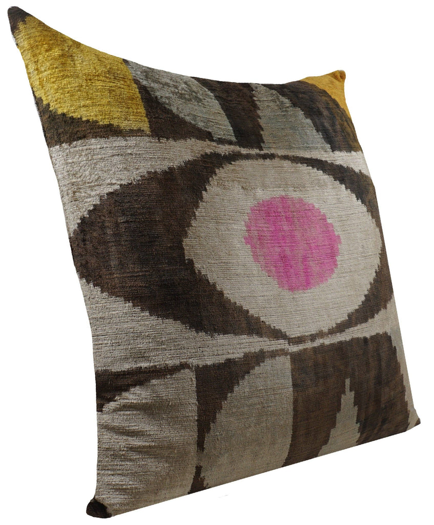 Decorative pillow with eye-shaped pattern.