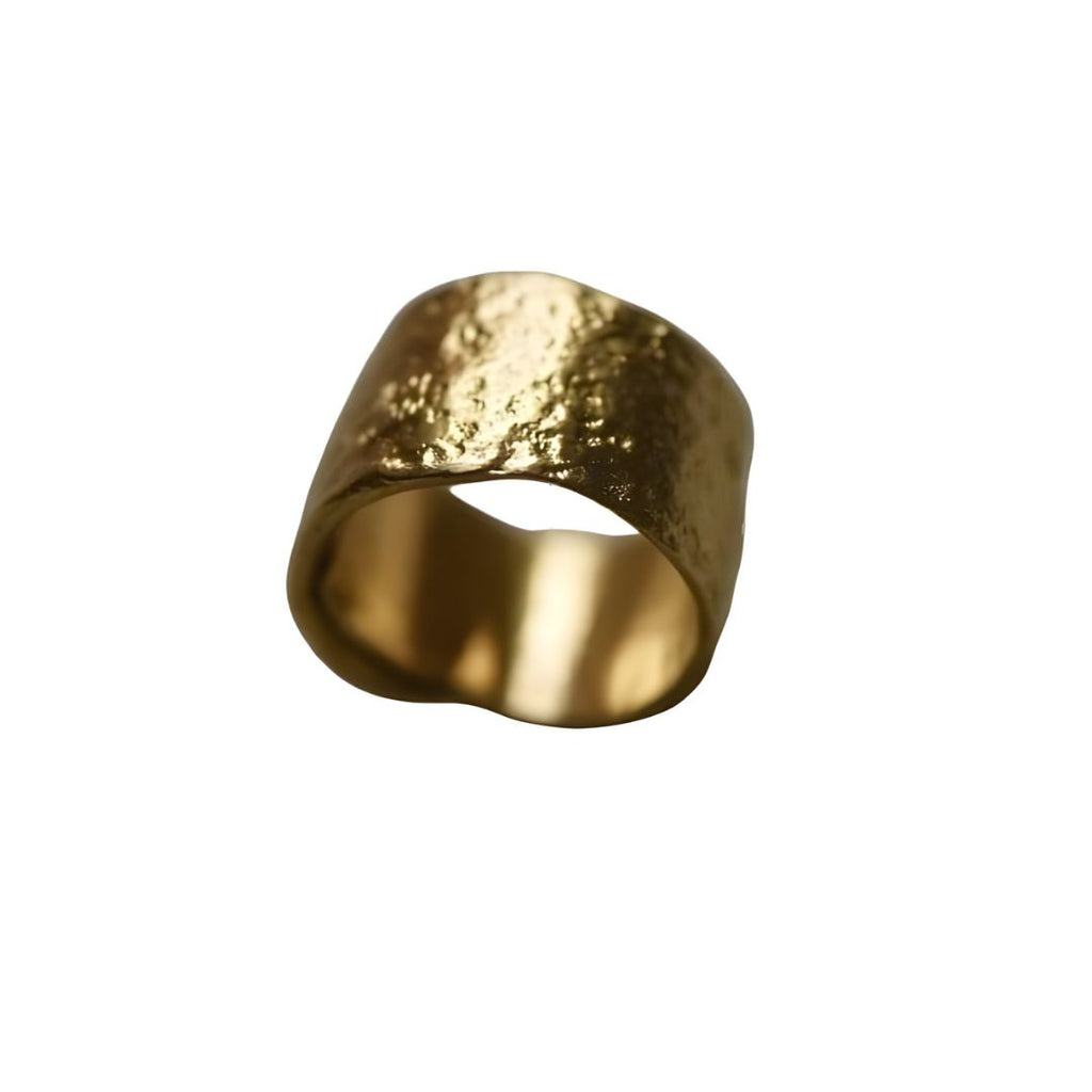 Gold ring with a textured surface on a white background