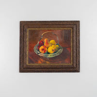 Framed painting of a still life with fruits on a white background
