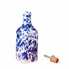 Decorative bottle with blue and white abstract pattern on a pink background
