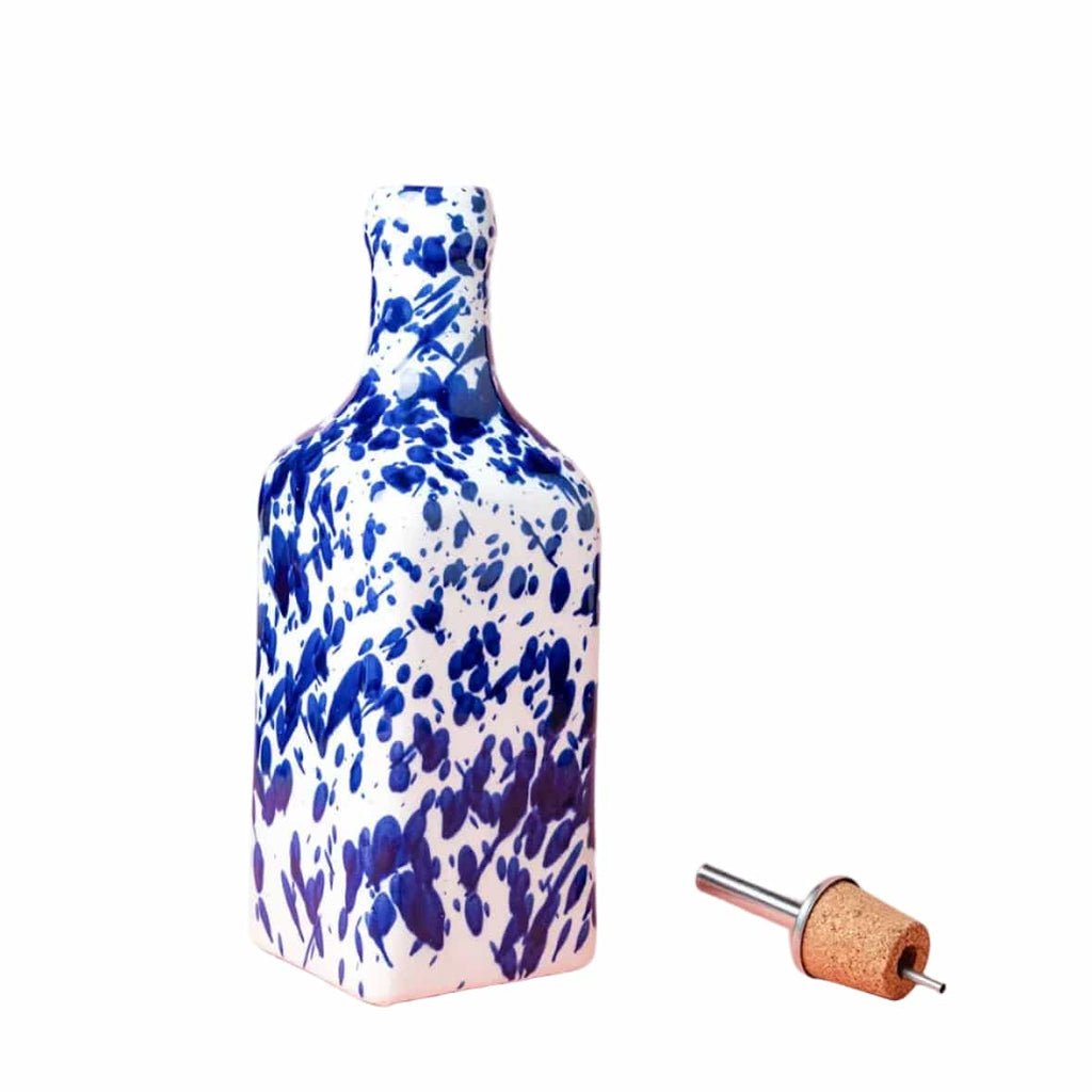 Decorative bottle with blue and white abstract pattern on a pink background
