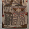 A square handmade textile wall hanging or quilt featuring stylized Native American-inspired motifs, including a central eagle, a figure on the left, geometric patterns, and red and brown accents on a beige fabric background.