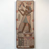 An Egyptian-style woven wall hanging or tapestry featuring a standing figure in profile with striped garments and headdress, set against a beige background with brown, red, and blue details, displayed against a plain white wall.