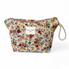 Floral-patterned pouch with a visible brand label on a white background