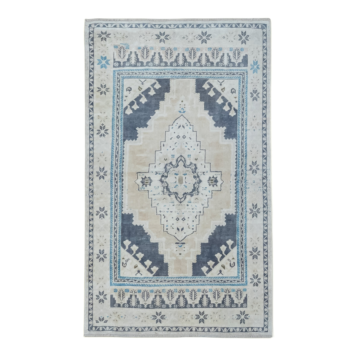 A rectangular area rug with a traditional medallion pattern in beige, light blue, and navy, shown flat against a white background.