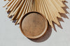 Brown Reactive Glaze Plate displayed with a dry palm leaf 