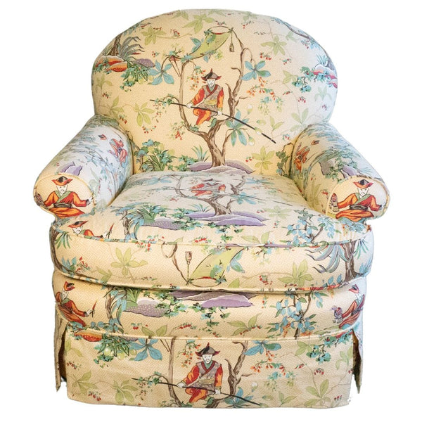 Upholstered armchair with floral and figure print.