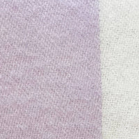 A close-up of a soft knit fabric texture showing a vertical color-blocked pattern with lavender purple on the left and off-white/cream on the right.