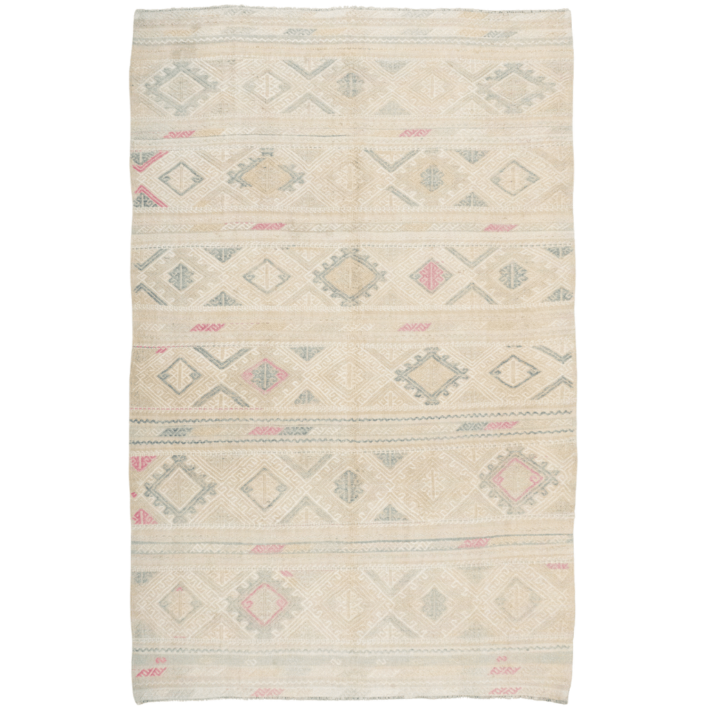 Handwoven wool Kilim rug with white, sage green, light blue, gold, tan, and cream tones. Modern Nomad Home Denver CO