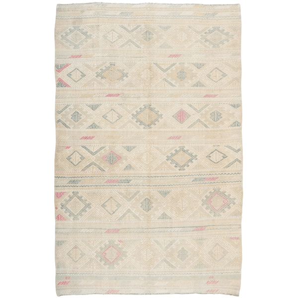 Handwoven wool Kilim rug with white, sage green, light blue, gold, tan, and cream tones. Modern Nomad Home Denver CO