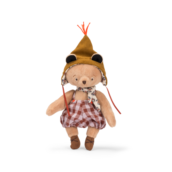 Stuffed teddy bear wearing a hat and plaid outfit on a white background