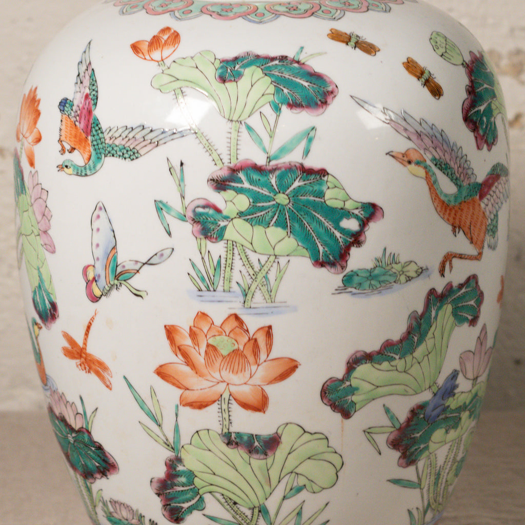 Decorative ceramic vase with colorful floral and bird patterns on a white background