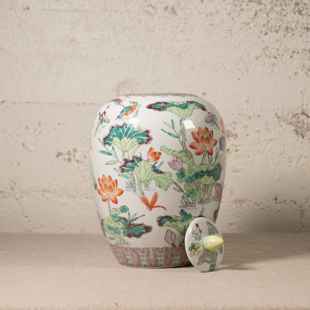 Decorative ceramic jar with floral patterns on a textured surface