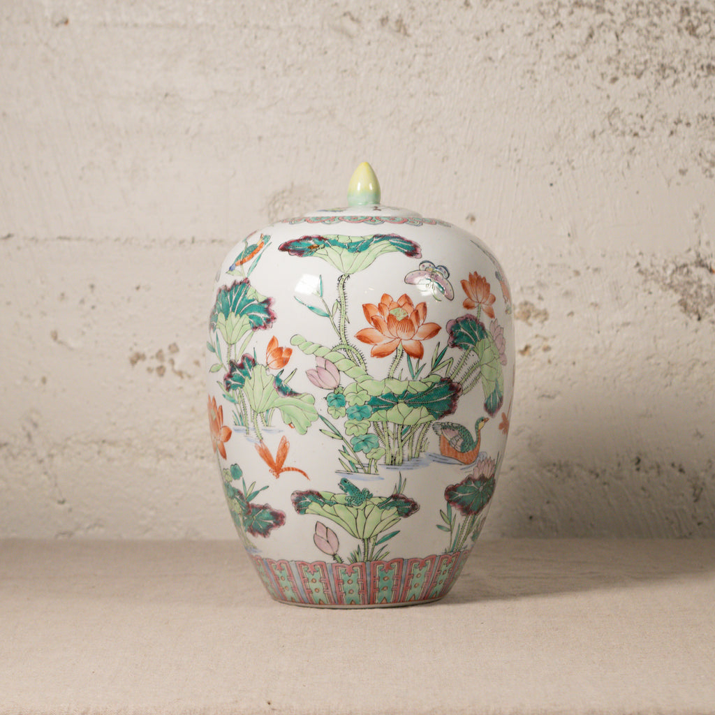 Decorative ceramic jar with floral patterns on a textured surface