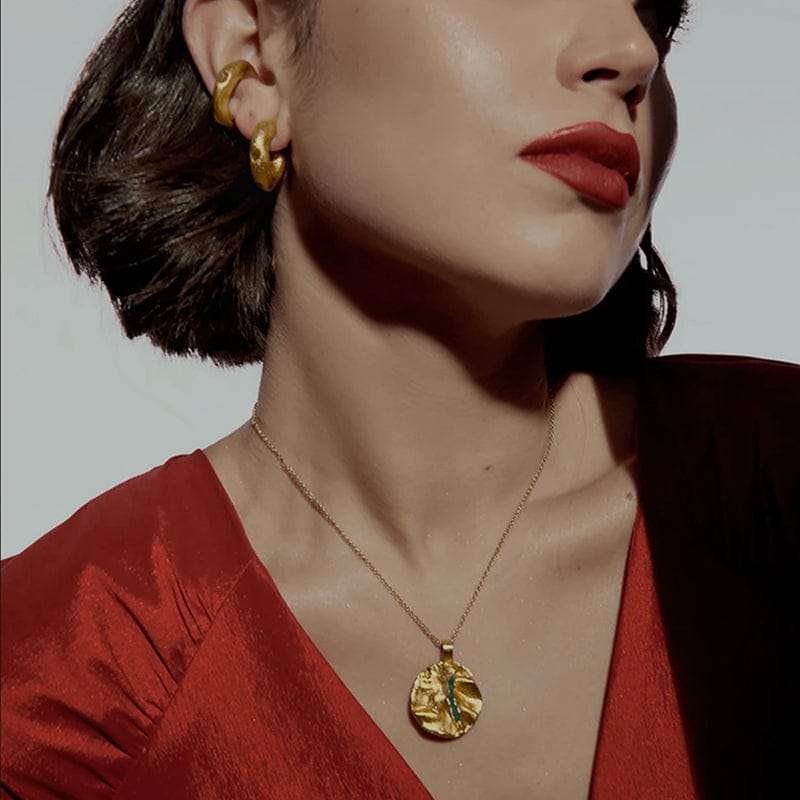 Woman wearing gold earrings and necklace