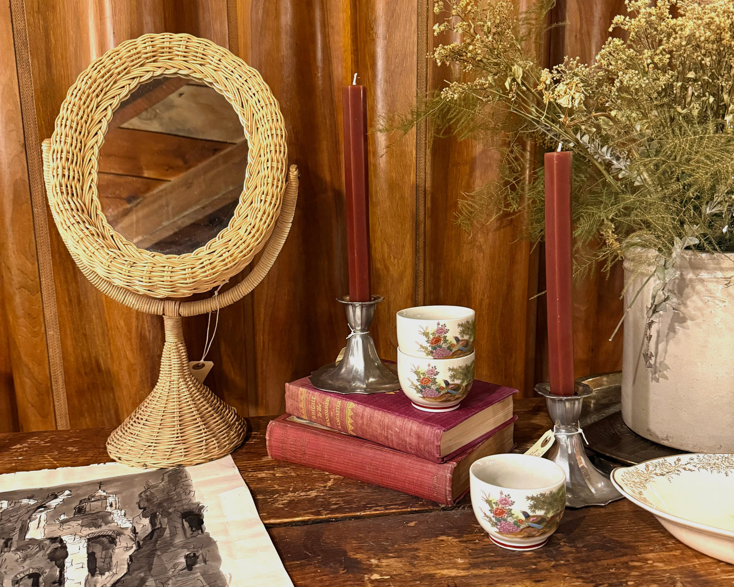 Wicker mirror, candles, books, and vintage decor (H_H2025-edit)