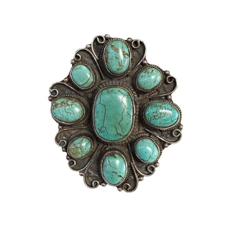 Turquoise stone brooch on a white background
