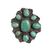 Turquoise stone brooch on a white background