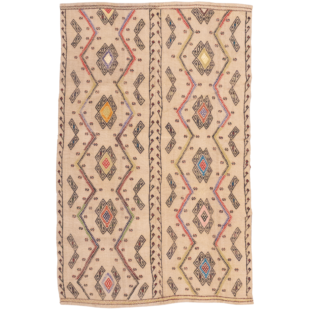 Handwoven flatweave Kilim rug with tribal diamond and zig-zag pattern in beige, black, red, blue, and pink.