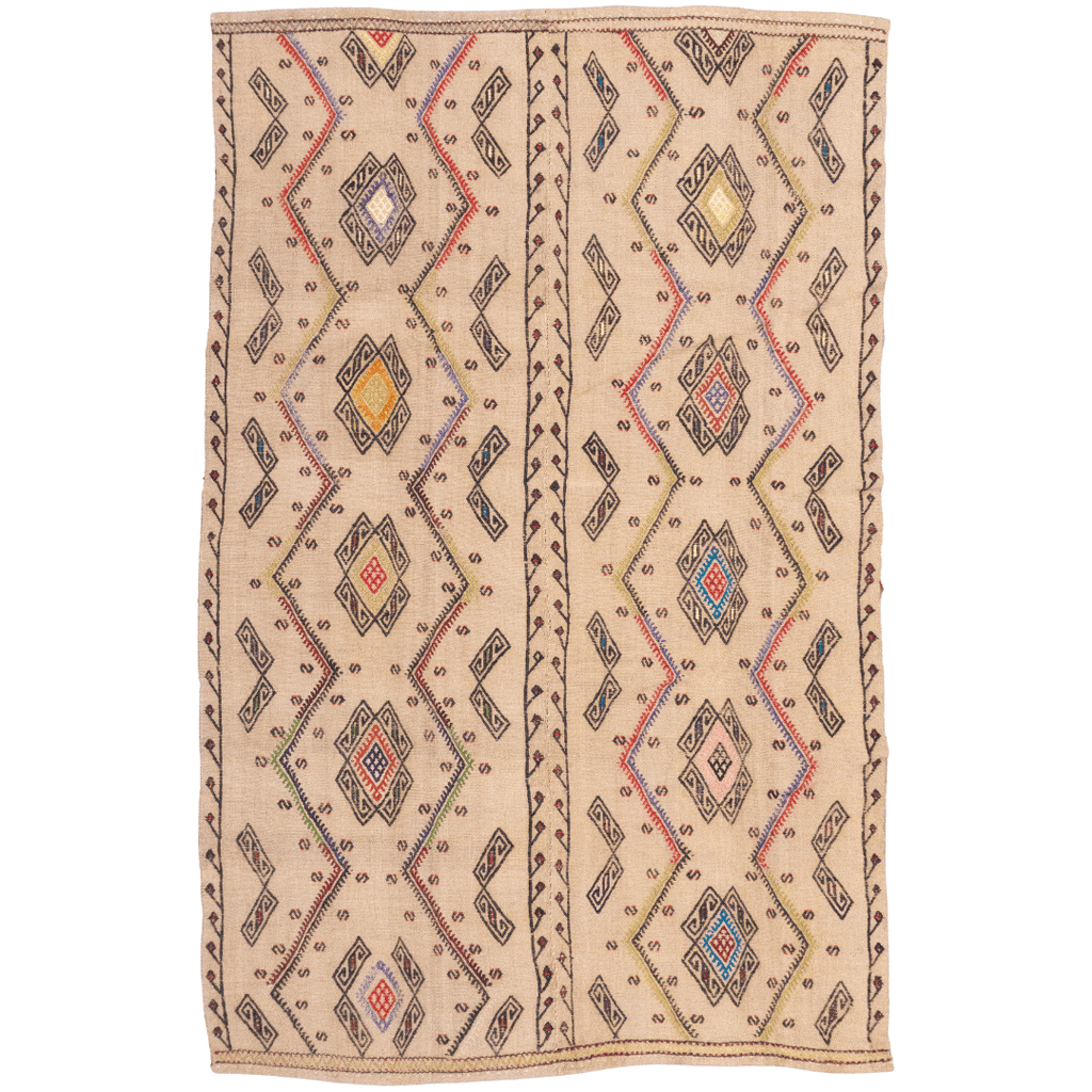 Handwoven flatweave Kilim rug with tribal diamond and zig-zag pattern in beige, black, red, blue, and pink.