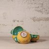 Three ceramic bowls with green interior and exterior on a textured surface.