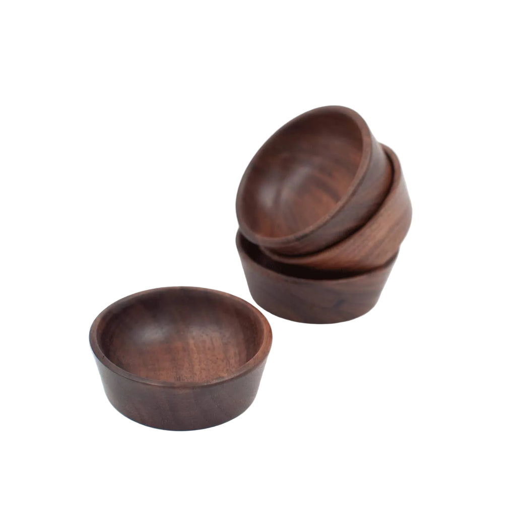 Set of three wooden bowls on a white background