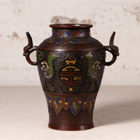 An antique Japanese enamel vase with dragon handles, featuring a dark bronze-brown base with vibrant green, blue, and gold decorative details.