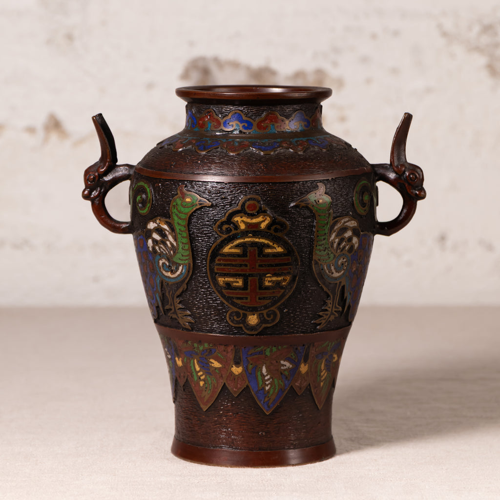 An antique Japanese enamel vase with dragon handles, featuring a dark bronze-brown base with vibrant green, blue, and gold decorative details.