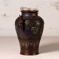 An antique Japanese cloisonne enamel vase with a dark brown lacquered base, featuring vibrant blue, green, and gold floral and dragon motifs, set against a neutral textured beige background.