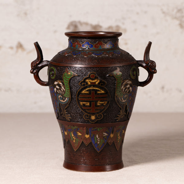 An antique Japanese enamel vase with dragon handles, featuring a dark bronze-brown base with vibrant green, blue, and gold decorative details.