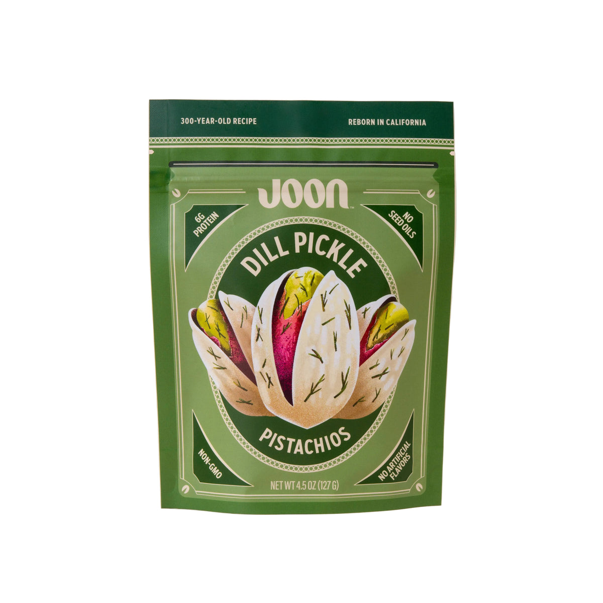 Green package of JOON Dill Pickle Pistachios on a beige background