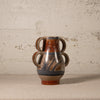 Ceramic vase with floral patterns on a textured surface and background