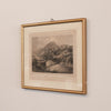 Framed black and white landscape print on a beige wall