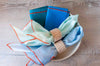 Linen Mix Napkins (blues) styled with napkin rings in a bowl 