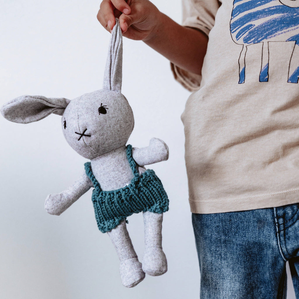 Lionel Rabbit being held by the ear by a child 