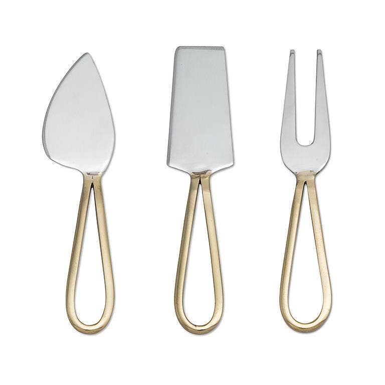 Set of three silver cheese tools with gold handles on a white background