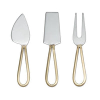 Set of three silver cheese tools with gold handles on a white background