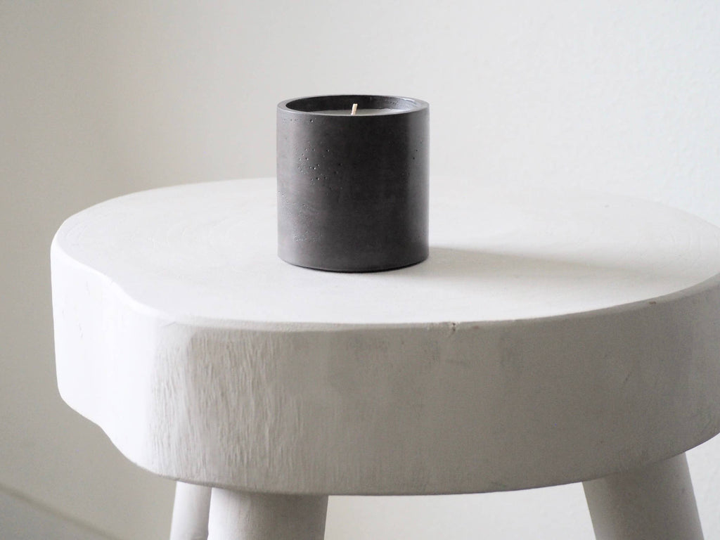 Makana concrete candle Nightfall displayed on a white stool 