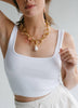 Maxi Emmie Necklace being modeled by a woman wearing white 